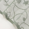 Translucent sun and moon lace door curtain in a muted sage green color