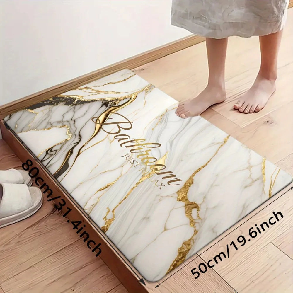 A rectangular marble pattern door mat with gold veining placed on a wooden floor.
