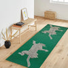 A long emerald green runner rug featuring a silver animal print design on a light wood floor.