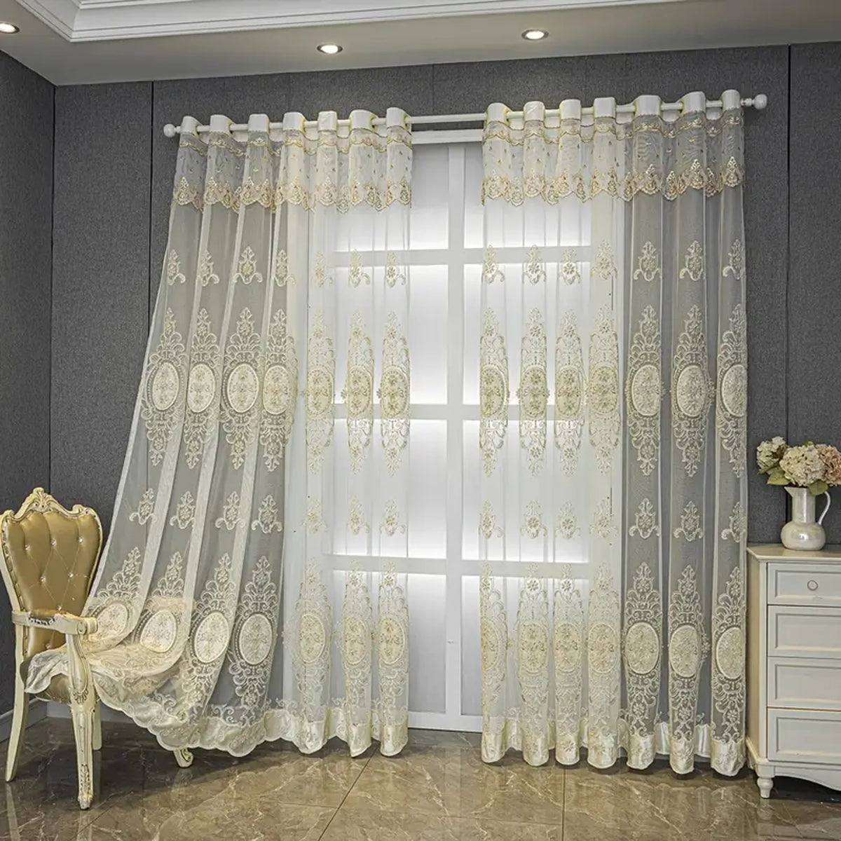 White sheer curtain with beige embroidery and punched-hole design hanging in a modern room.