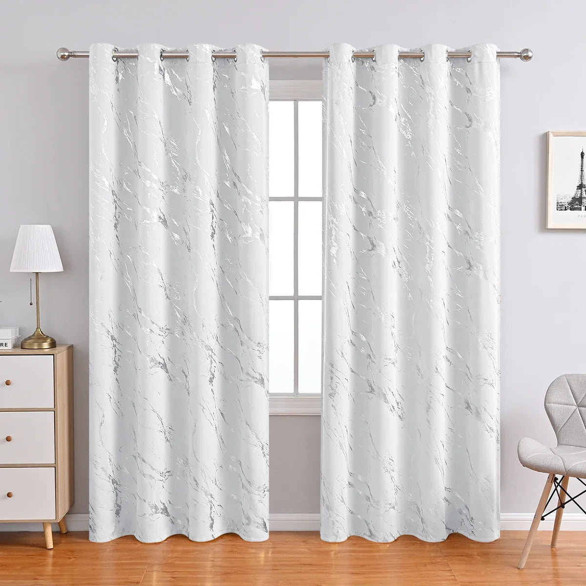 White marble printed curtain panels hanging in a window frame