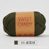 A ball of olive green yarn labeled Sweet Candy with Chinese characters on the packaging.