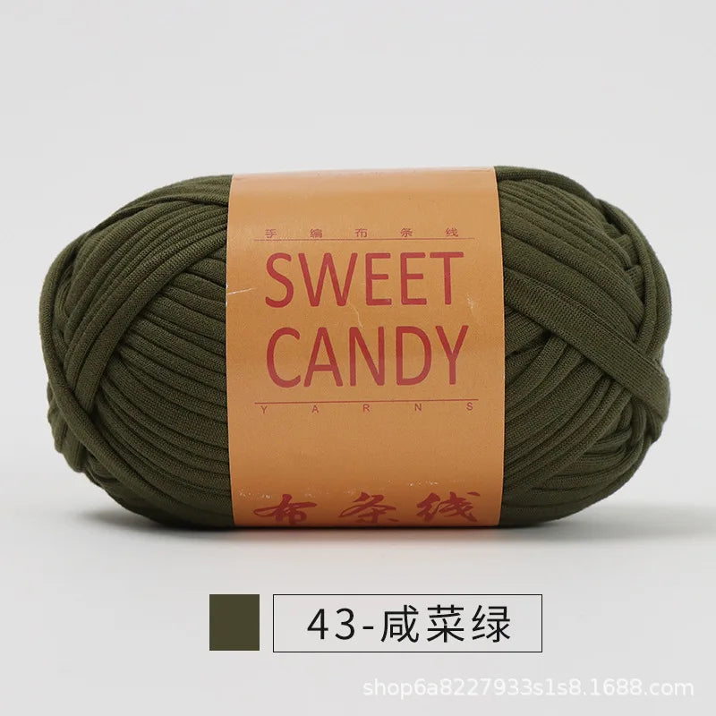 A ball of olive green yarn labeled Sweet Candy with Chinese characters on the packaging.