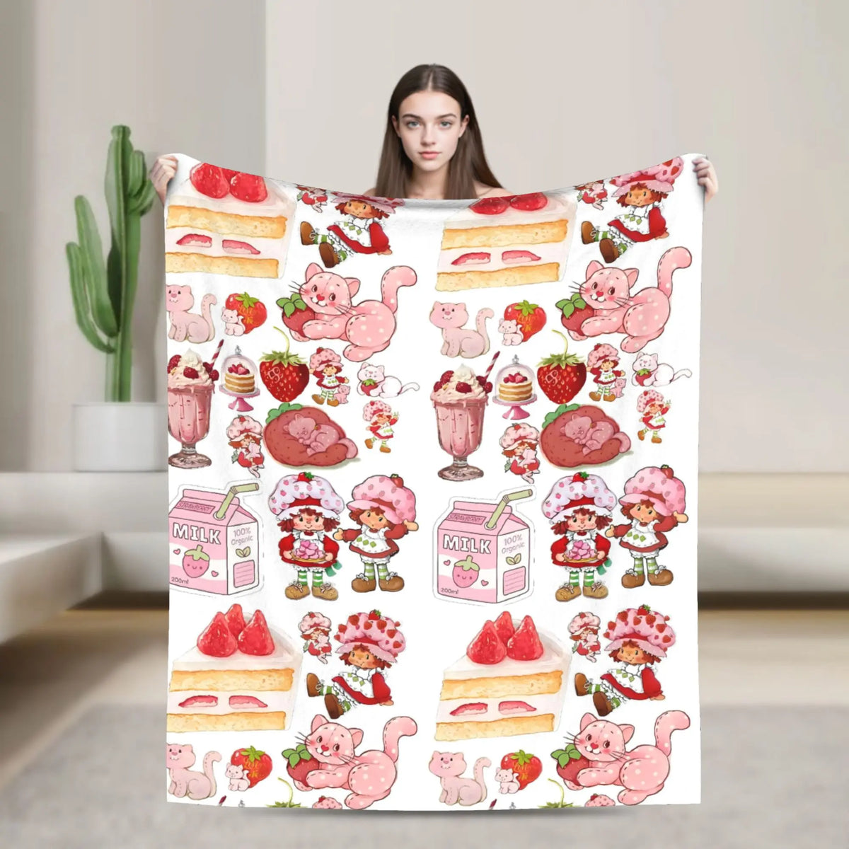 A pink strawberry shortcake plush throw blanket featuring cute pink animals and fruit designs.