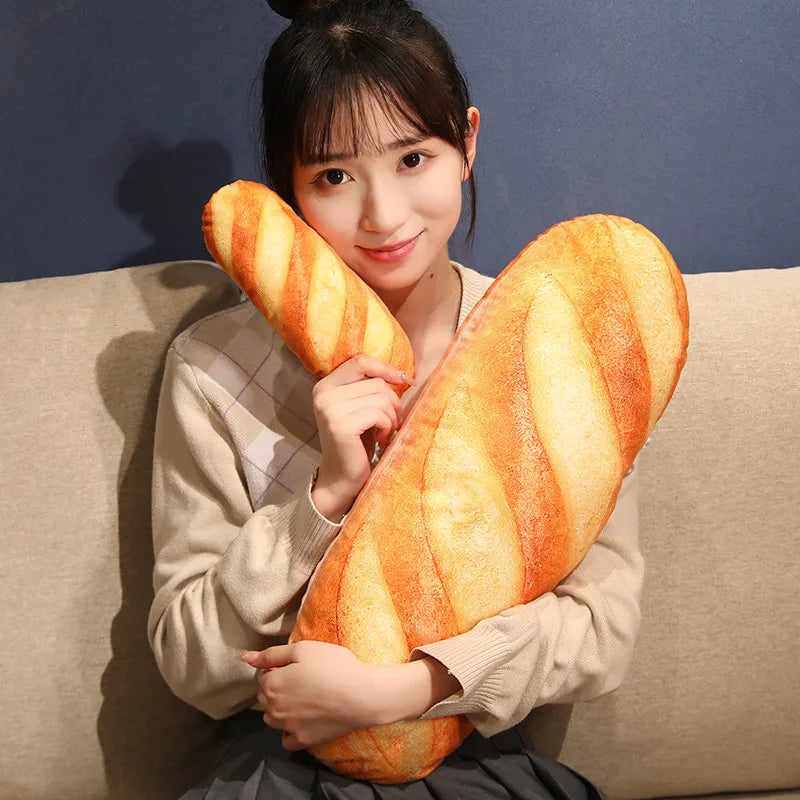 A woman is holding a large, orange French bread plush pillow against her chest.