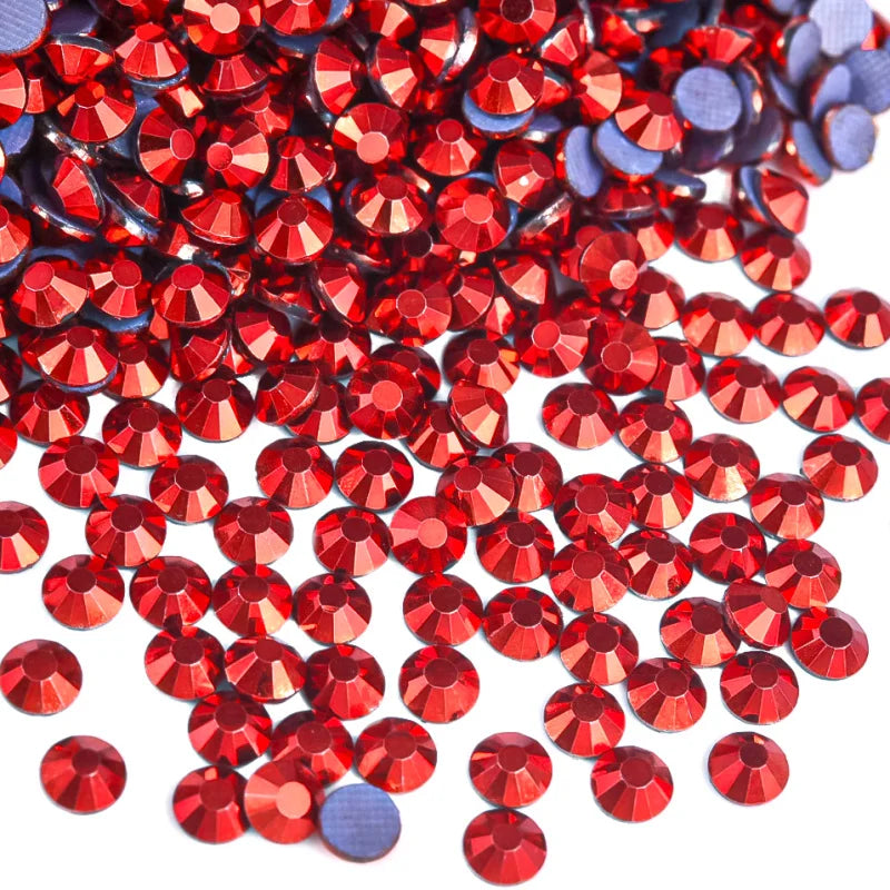 A close-up view of a pile of red and blue flatback glass rhinestones.