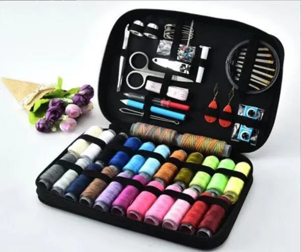 A black portable sewing kit box showing various tools, scissors, and spools of thread.