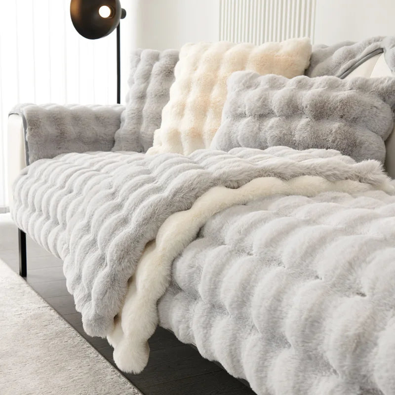 A fluffy gray and cream textured duvet cover with quilted details displayed on a bed.