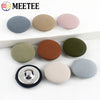 A set of round fabric-covered shank buttons in various shades of gray, beige, and olive green.