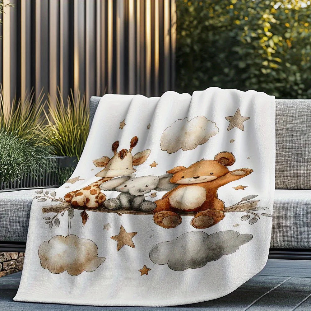 A white blanket featuring a watercolor illustration of a bear and a fawn resting on clouds and stars.