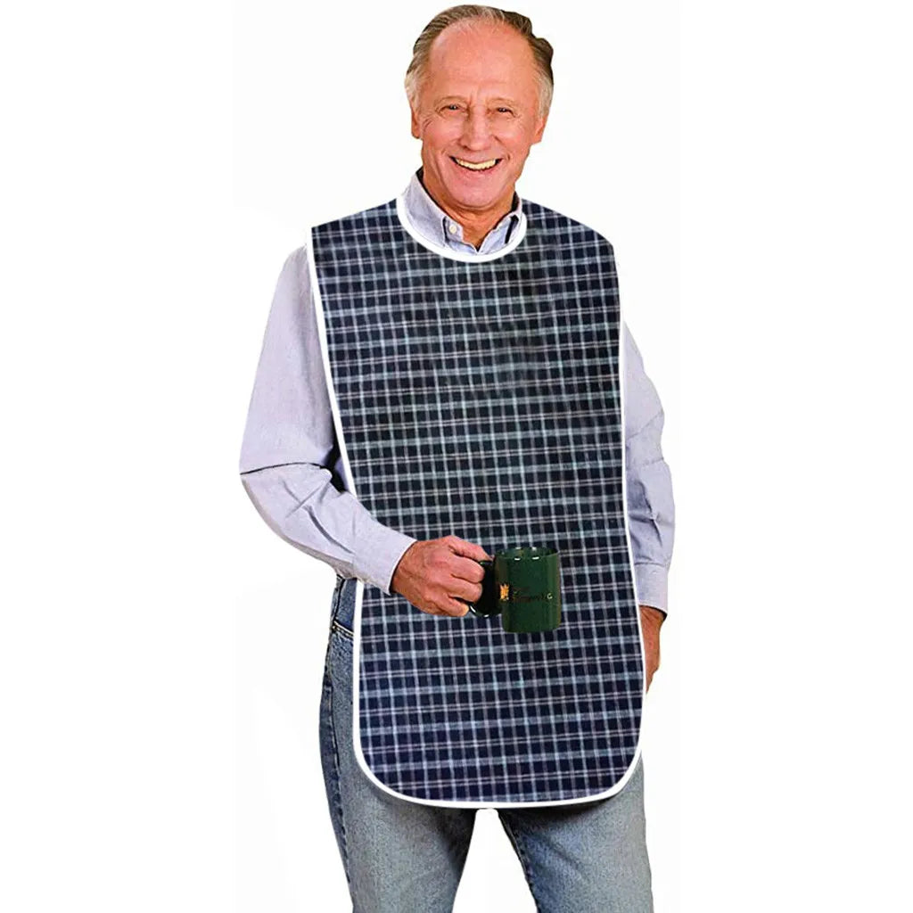 An older man wearing a blue shirt and jeans, holding a dark green bib with a plaid pattern.