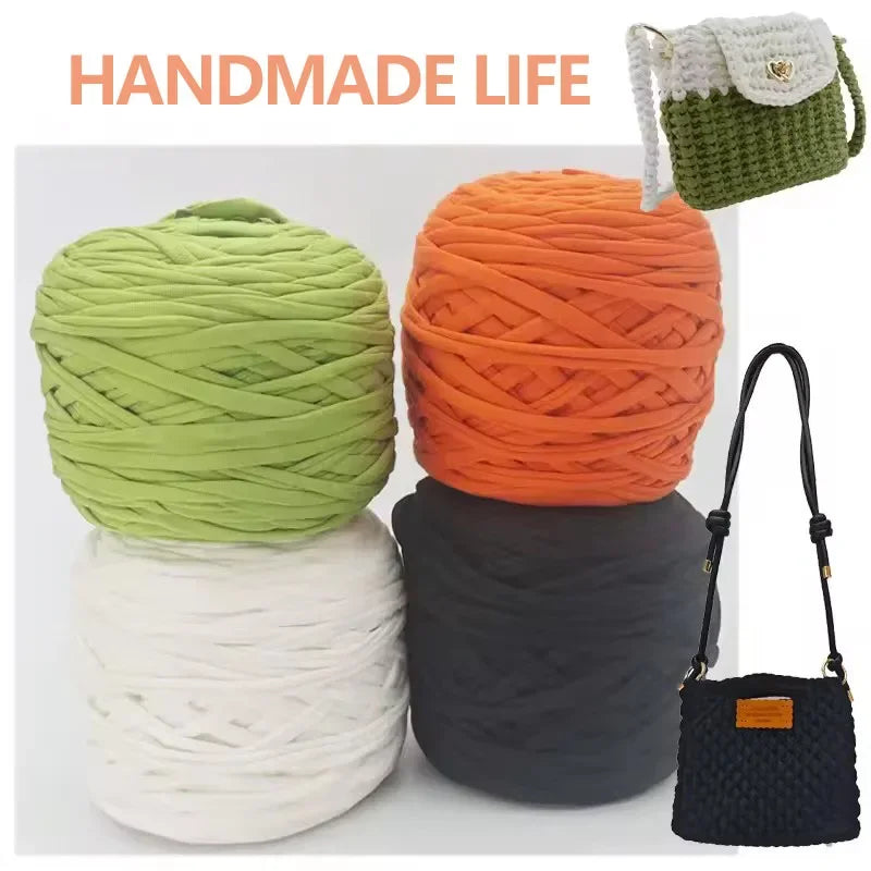 A collection of hand-made soft T-shirt yarn in various colors including lime green, orange, white, and black, with a green st