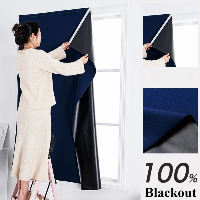 A woman is installing blackout curtains on a window, showing the fabric and installation process.