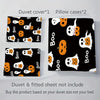 A set of black duvet covers and pillow cases featuring a white ghost pattern with orange accents.
