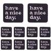 Four black embroidered patches with the text have a nice day.