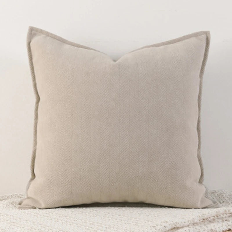 A solid beige chenille throw pillow cover with a subtle vertical stitch texture.
