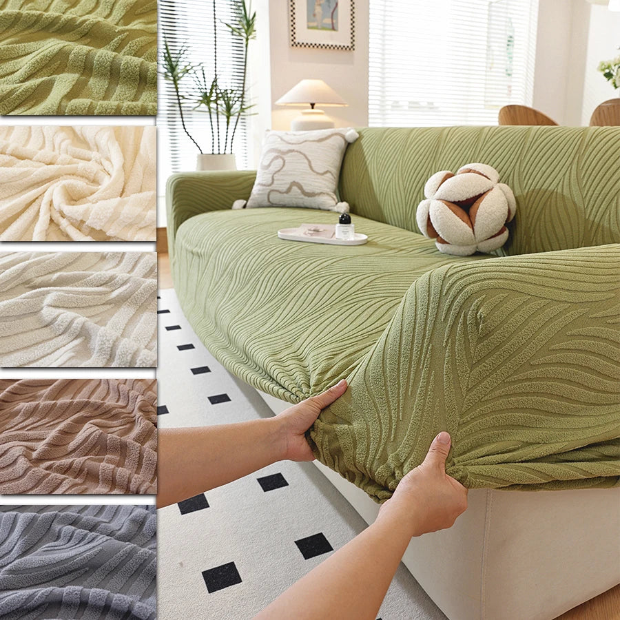 Close-up view of a sage green stretch sofa cover with an elegant plant pattern texture and elastic edge.