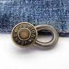 A round brass button with the word FASHION engraved on it and a silver spring-loaded loop.