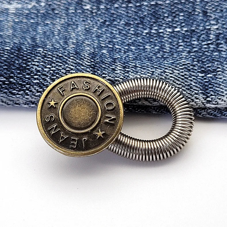 A round brass button with the word FASHION engraved on it and a silver spring-loaded loop.