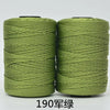 Two spools of light green yarn or cord used for hand knitting and crochet crafting