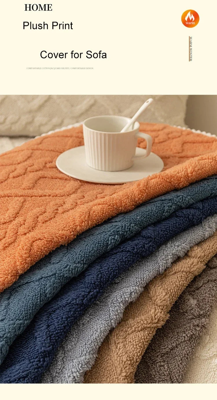 A stack of plush winter sofa cushion covers in various earthy and cool tones, including orange, blue, gray, and beige.