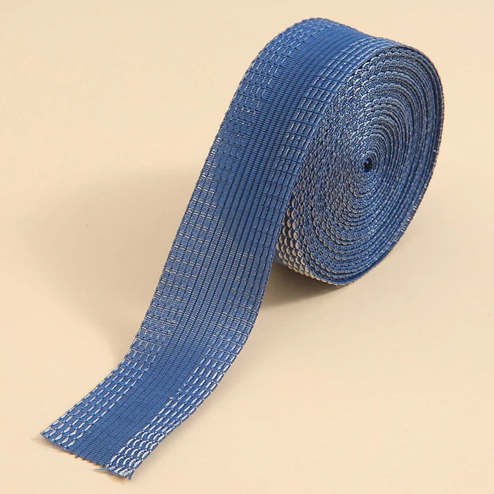Blue self-adhesive hem tape rolled up, showing the textured fabric strip for sewing or repair.