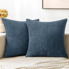 A set of four navy blue corduroy throw pillow covers with a vertical ribbed texture and a patchwork design.