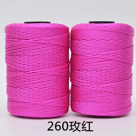 Two spools of bright pink hand knitting and crochet cord for crafting