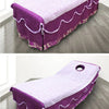 Purple disposable non-woven beauty and salon sheet draped on a floor.