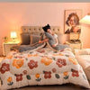 A cozy bedroom scene featuring a plush fleece blanket with a velvet finish on a bed.