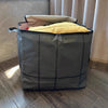 A large gray fabric storage bag with a zipper is open, revealing yellow padding inside.