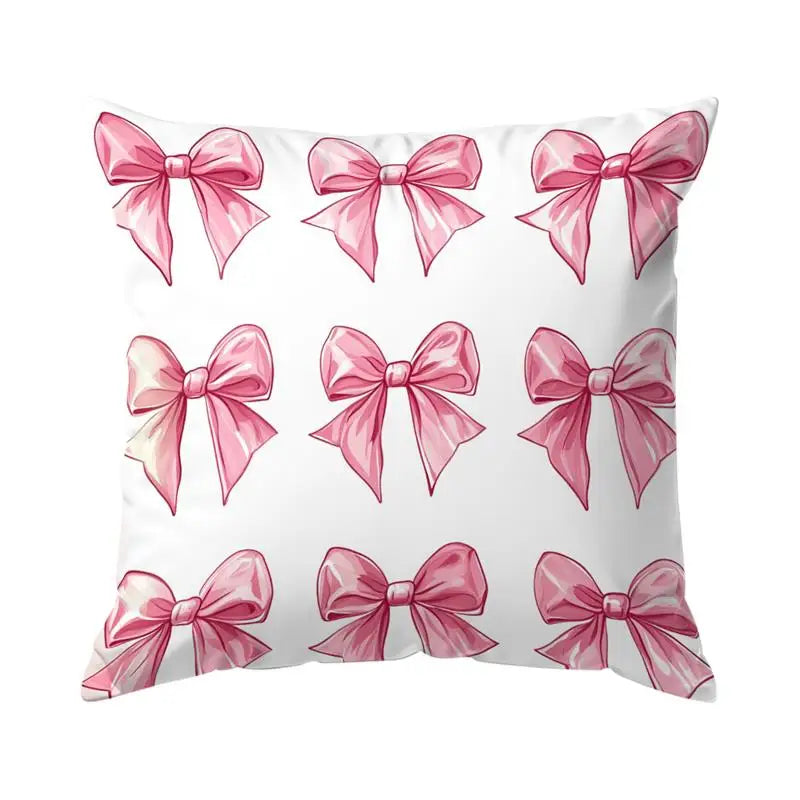 Decorative pillow cover featuring a pattern of pink bows on a white background.