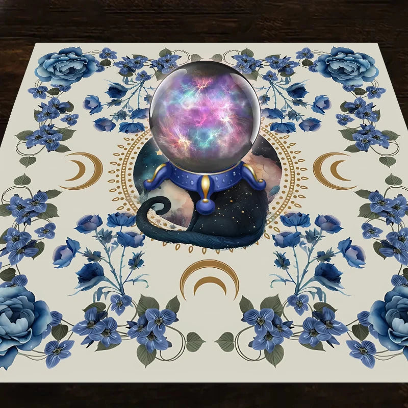 A mat featuring a central iridescent sphere surrounded by blue flowers and celestial elements for tarot readings.