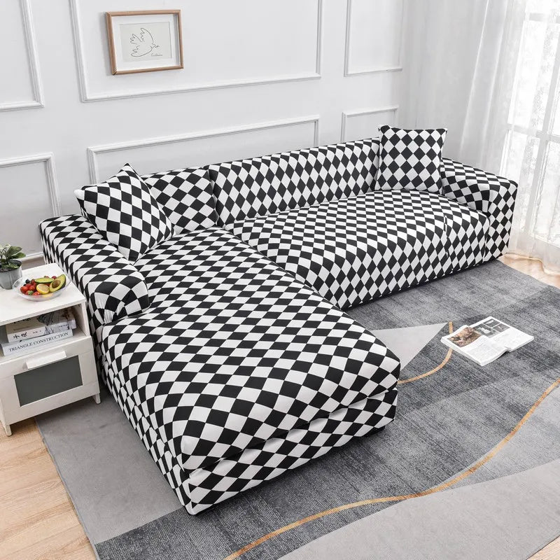 A black and white checkered printed sofa protector cover displayed on a gray rug.