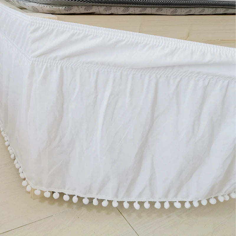 White elegant elastic bed skirt with decorative fringe