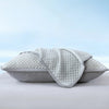 A light gray summer cooling bean pillow cover folded and displayed on a white surface.