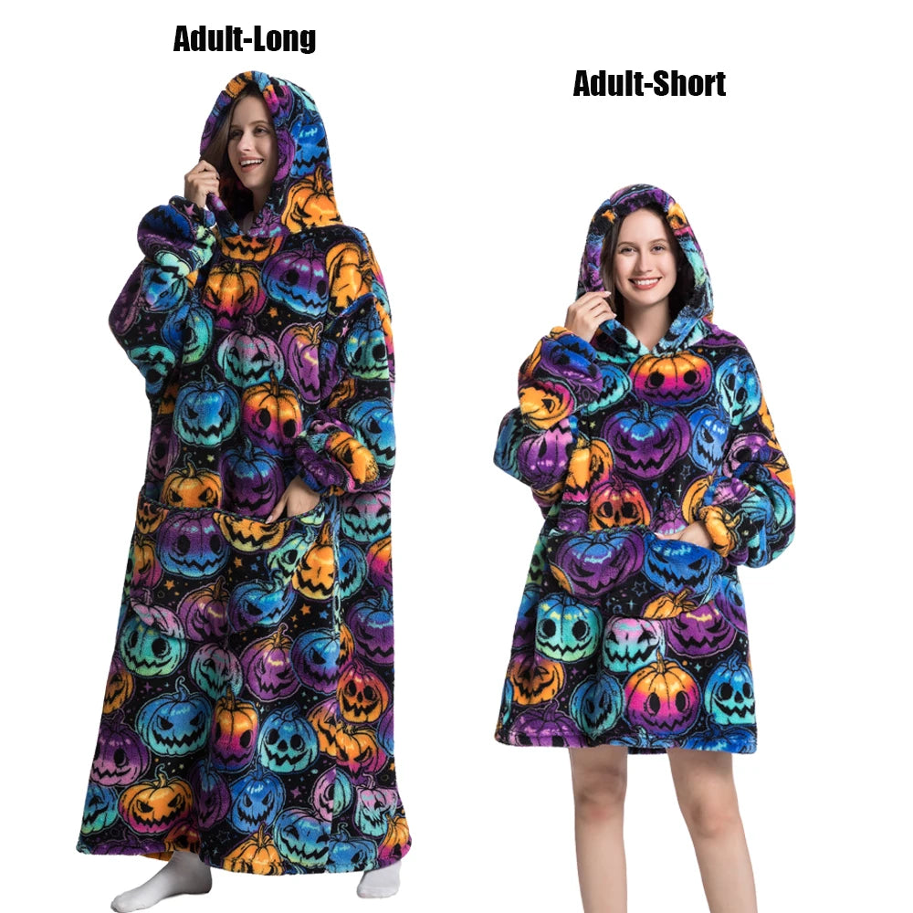 A woman models an adult-long and adult-short plush fleece blanket hoodie featuring a Halloween pumpkin print pattern.