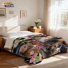 A funny monkey print flannel blanket spread out on a bed with natural light.