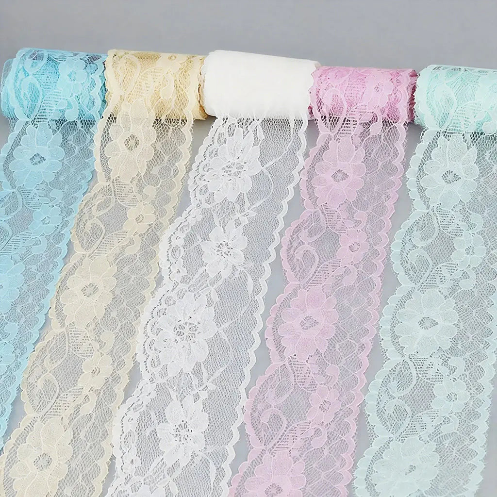 Rolls of decorative lace ribbon in various pastel colors including light blue, cream, white, pink, and mint green.