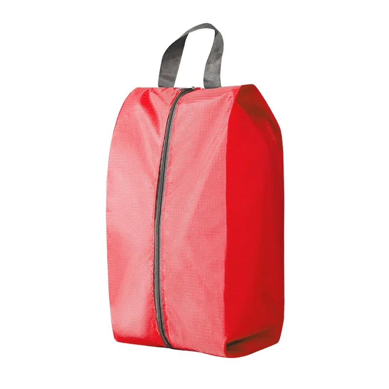 A red foldable shoe and travel organizer bag with a black zipper and gray carrying straps.