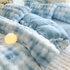 A light blue and white plaid fleece duvet cover with fluffy texture displayed on a bed.