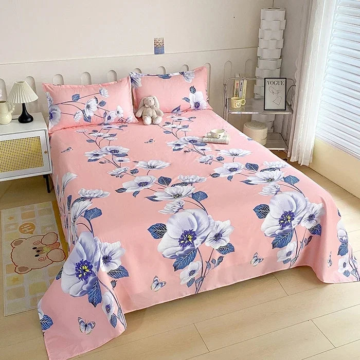 Pink flat bed sheets with blue and white floral print on a double bed