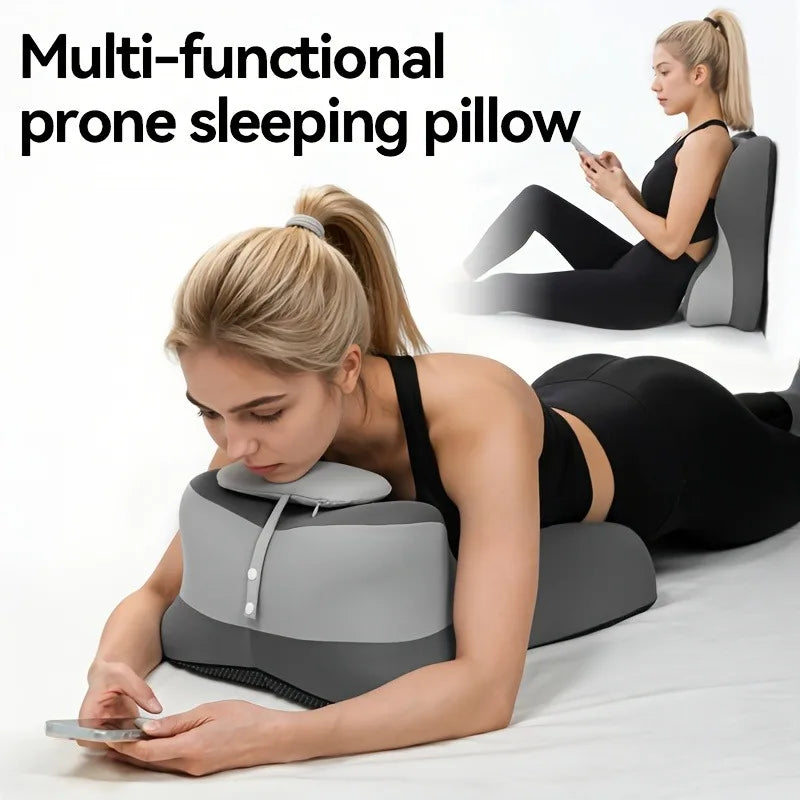 A woman is using a multi-functional prone sleeping pillow while lying down and looking at her phone.