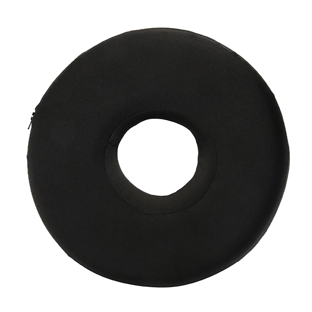 A black, circular ear piercing pillow designed for comfort during sleep.