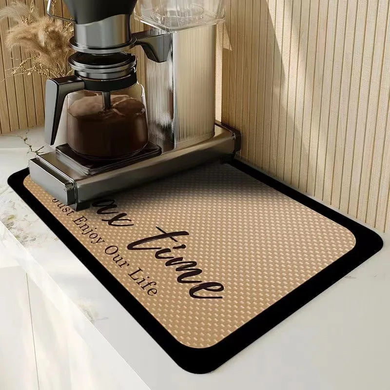 A silver insulated coffee cup drainer mat with a brown coffee cup sitting on it.