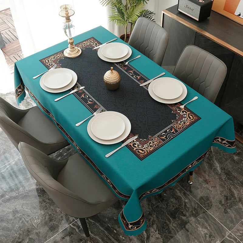 A teal rectangular tablecloth set for dining or party decor featuring white plates and a centerpiece.