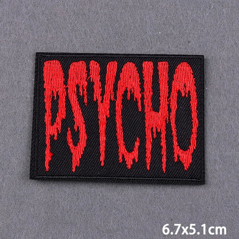 A black embroidered patch with the word PSYCHO in dripping red font