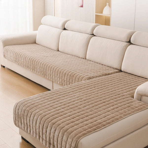 A beige L-shaped corner flannel sofa cover with light cream upholstery and quilted texture.