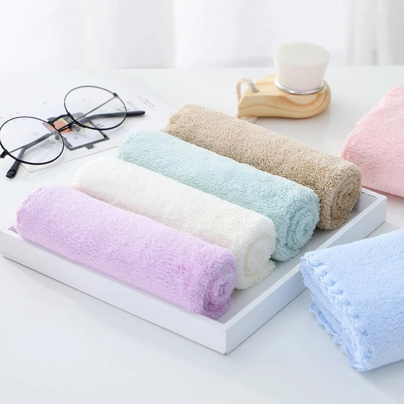 A set of ten luxury coral velvet cleaning face towels in various pastel colors arranged on a white tray.