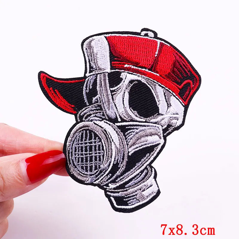 Embroidered skull iron-on patch featuring a red cap and a detailed skull design on black fabric